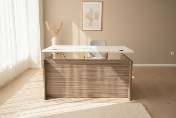 Office desk with a white top and wooden side panel in an indoor setting